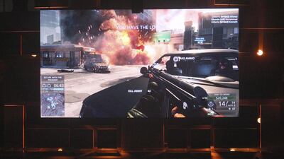 People are shown a Los Angeles street battle scene in the beta version of Battlefield: Hardline at the Electronic Arts (EA) World Premiere: E3 2014 Preview. David McNew / Reuters
