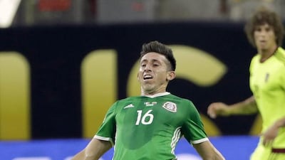 Mexico midfielder Hector Herrera is tangled with Venezuela midfielder Luis Manuel Seijas. David J Phillip / AP Photo