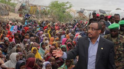July 26 2011: Somali prime minister Abdiwali Mohamed Ali, right, visiting the largest displaced persons camp in Mogadishu to assess the scale of drought victims flooding into the capital. The UN will airlift emergency rations this week to parts of droug???