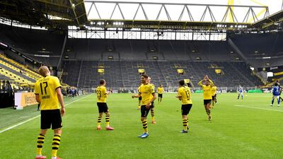 Dortmund's Erling Haaland, left, celebrates after scoring the opening goal. AP