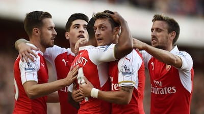 After an inconsistent first two seasons at Arsenal, Mesut Ozil, centre, has emerged as the Premier League's leading play-maker this season. Dylan Martinez / Reuters