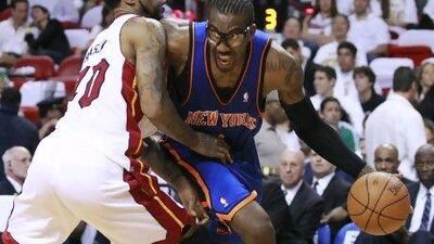 Amare Stoudemire, right, exited Miami with his left hand and arm in a sling after New York's 104-94 loss to the Heat in Game 2.