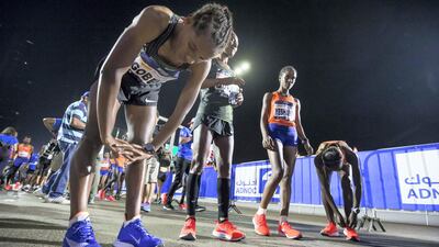 Elite runners warming up before the race at the Adnoc Abu Dhabi Marathon. Leslie Pableo for The National
