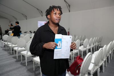 Christopher Kyeyunemr, from Uganda, showing his exit pass. Pawan Singh / The National