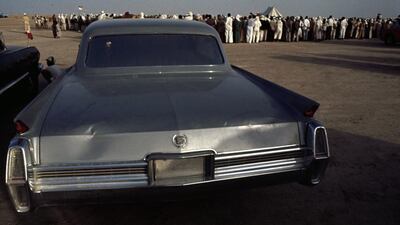 An American Cadillac car parked at a desert gathering in 1964.