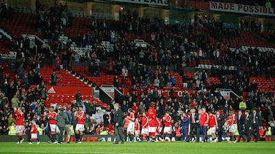 Manchester United players do a lap of honour in front of a two-thirds filled Old Trafford stadium following their win over Bournemouth on Tuesday night. Carl Recine / Reuters