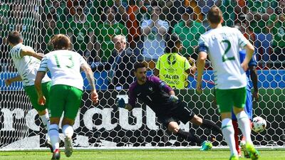 Ireland midfielder Robert Brady shoots to score against France’s goalkeeper Hugo Lloris. Franck Fife / AFP