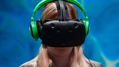 A visitor tests the new Vive steam VR virtual device at the HTC stand on the second day of the Mobile World Congress in Barcelona on February 23, 2016. AFP