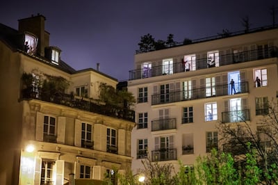 Parisians applaud from their windows to support healthcare workers while France is under lockdown to contain the spread of coronavirus, on March 21, 2020. EPA