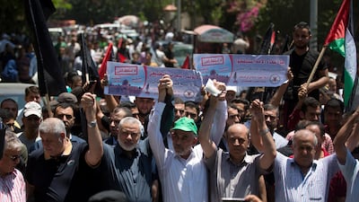 Head of the Hamas political bureau, Ismail Haniyeh, third from left, and Hamas leader in the Gaza Strip Yahya Sinwar raise their hands up with leaders of the other Palestinian factions as they attend a protest against the White House's long-awaited plan for Mideast peace, in Gaza City, Wednesday, June 26, 2019. AP