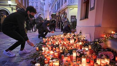 People light candles at a makeshift memorial at the scene of the attack in Vienna. Getty Images
