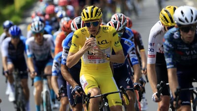 Tadej Pogacar of UAE Team Emirates, in the leader's yellow jersey, rehydrates during the stage. EPA