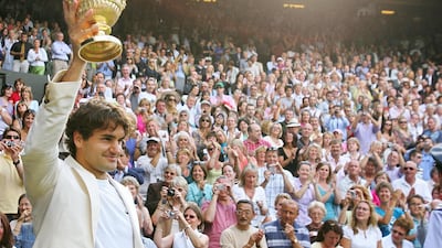 Roger Federer celebrates his fourth consecutive Wimbledon title after beat Spain's Rafael Nadal in 2006. AFP