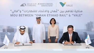 Ahmed Al Hashemi, chief executive of Oman and Etihad Rail Company, and Rogerio Nogueira, director of business development at Vale, sign the agreement, witnessed by Suhail Al Mazrouei, Minister of Energy and Infrastructure and chairman of Oman and Etihad Rail Company, and Elaina Zugaib, Brazi's ambassador to the UAE. Photo: Etihad Rail