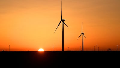 Wind turbines operate at sunrise in the Permian Basin. Diamondback's two acquisitions announced on Monday strengthen its position in the sub-basin around its headquarters in Midland, Texas. Reuters