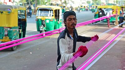 A man coats kite strings with glass powder ahead of the Hindu Uttarayan festival in Ahmedabad, Gujarat, India. AFP