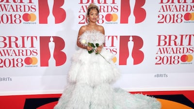 We love Rita Ora's artfully messy and angelic hair here, and this feather Ralph & Russo dress is certainly a statement. We never thought we'd like mint-to-white ombre peplum feathers so much. EPA