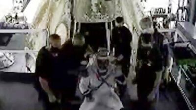 Astronaut Doug Hurley waves as he is assisted out of the SpaceX capsule. AP