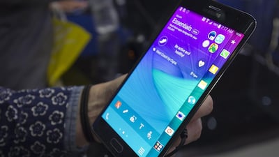 A visitor holds a Samsung Galaxy Edge smartphone during the International Consumer Electronics Show in Las Vegas in January. The latest iteration of the Edge is expected to be announced in Barcelona. Steve Marcus / Reuters
