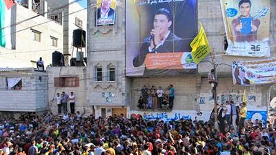 Crowds await the arrival of the Palestinian winner of Arab Idol, Mohammed Assaf, in his home at Khan Yunis in the Gaza Strip last month. Said Khatib / AFP