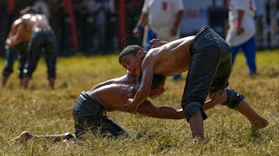 Young wrestlers compete during the 664th annual Historic Kirkpinar Oil Wrestling championship, in Edirne, northwestern Turkey, Sunday, July 6, 2025. (AP Photo / Khalil Hamra)