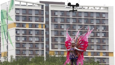 A performer in a fantasy play is elevated by a high wire at Wanda City theme park. Rolex Dela Pena / EPA