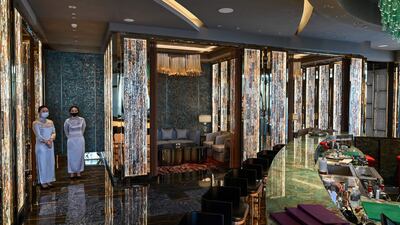 Employees stand in the bar of the J Hotel, the world's highest luxury hotel.