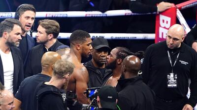 Anthony Joshua, left, speaks to Jermaine Franklin after defeating Franklin in a heavyweight boxing match at The O2. AP