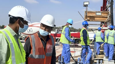 Contractors talk through work plans at the temple, which is located just off the E11 highway, about 30 minutes outside Abu Dhabi city. Khushnum Bhandari for The National