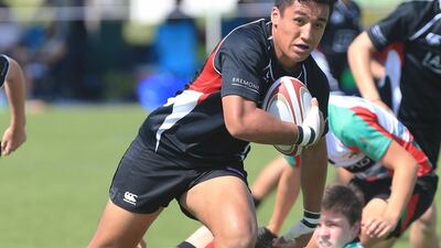 England international Ugo Monye interacts with children during his visit to the Etihad Airways Abu Dhabi Harlequins Junior Rugby tournament at Zayed Sports City in Abu Dhabi on Saturday. Ravindranath K / The National