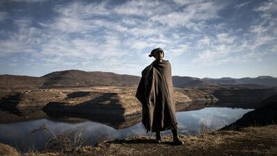 Shepherd Ntoaesele Mashongoane, 32, calls to his flock near the Katse dam in Lesotho on July 13, 2016. John Wessels / AFP