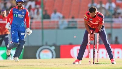 Punjab Kings' substitute fielder Harsal Patel, right, runs out Delhi Capitals' Kuldeep Yadav, who made 22 off 16. AP