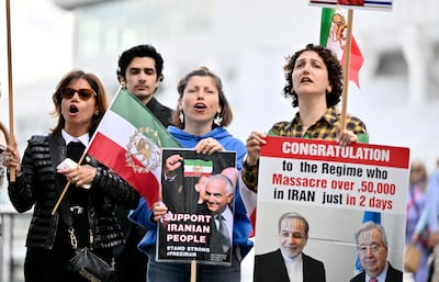 Protesters hold demonstration placards outside the Vancouver Convention Centre during the 76th Fifa Congress. Reuters