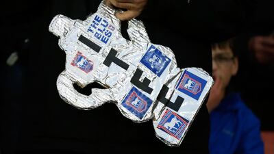 An Ipswich Town fan carries a makeshift trophy during the FA Cup third round match against Southampton on Sunday. Steve Bardens / Getty Images