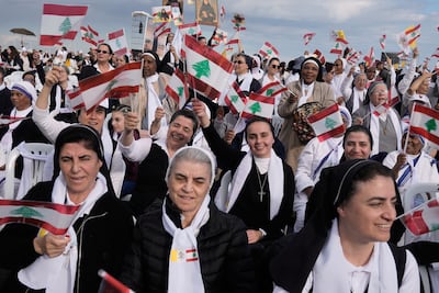 Nuns wave Lebanese and Vatican flags. AP