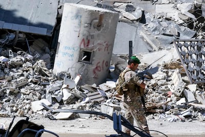A Lebanese army soldier walks past rubble in Nabatieh, southern Lebanon. AFP