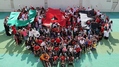 Students, teachers and staff at the Rashid Paediatric Therapy Centre celebrate Flag Day