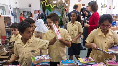 Pupils of Horizon School pack books into boxes to send to underprivileged children around the world. Alex Atack for The National