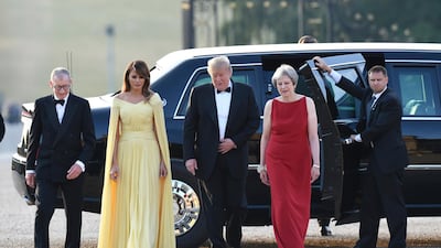 Theresa May, accompanied by her husband Philip, left, arrive with US President Donald Trump and his wife Melania for a black tie dinner at Blenheim Palace. AP