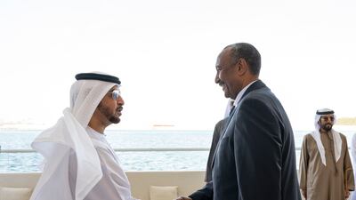 Sheikh Hamdan bin Zayed, Ruler's Representative in Al Dhafra region, greets Gen Al Burhan