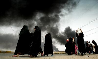 Iraqi women leave the besieged city of Basra in, 2003, after British and American troops invaded Jerry Lampen