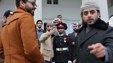 Emirati officer cadet Al Mansoori, centre, with family members after the Sovereign’s Parade, at the Royal Military Academy in Sandhurst, Britain. The parade marks the completion of 44 weeks of intensive training. AFP