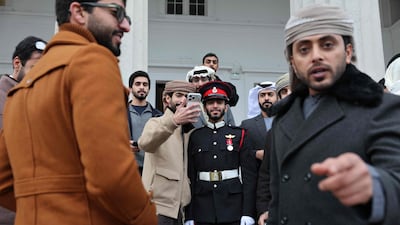 Emirati officer cadet Al Mansoori, centre, with family members after the Sovereign’s Parade, at the Royal Military Academy in Sandhurst, Britain. The parade marks the completion of 44 weeks of intensive training. AFP
