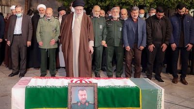 A handout picture provided by the office of Iran's Supreme Leader Ayatollah Ali Khamenei on December 28, 2023, shows him praying next to the coffin of of Razi Moussavi, a senior commander in the Quds Force of Iran's Islamic Revolutionary Guard Corps (IRGC) who was killed on December 25 in an Israeli strike in Syria, in Tehran. (Photo by KHAMENEI. IR / AFP) / === RESTRICTED TO EDITORIAL USE - MANDATORY CREDIT "AFP PHOTO / HO / KHAMENEI. IR" - NO MARKETING NO ADVERTISING CAMPAIGNS - DISTRIBUTED AS A SERVICE TO CLIENTS ===
