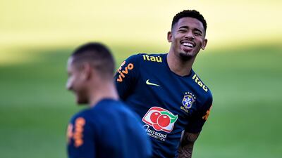 Gabriel Jesus shares a joke with a teammate during training with Brazil. EPA