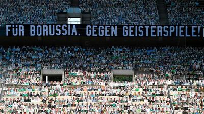 Cardboards with photos of Moenchengladbach fans are seen on the stands prior to the . The banners on the stands read: "For Borussia. Against ghost games!" AFP