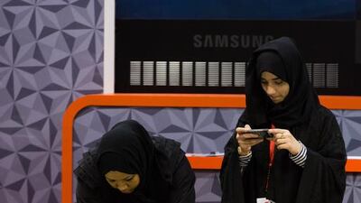 Visitors look at a model of Dubai World Central's Al Maktoum International Airport on display at the airport show. Duncan Chard for the National.