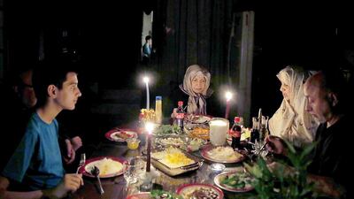 A family in Tehran breaks their Ramadan fast by candlelight after their electricity supply cut off in one of the Iranian capital's continual power cuts. Maryam Rahmanian for The National / July 17, 2014