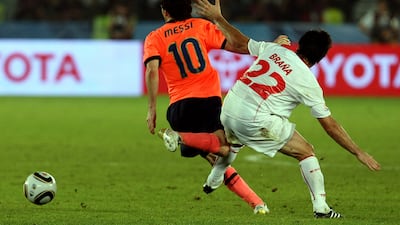 Barcelona's Lionel Messi is challenged by Rodrigo Brana of Estudiantes. AFP