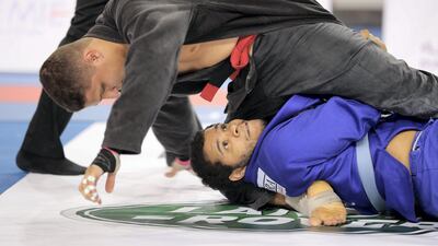 Khalid Ahmed ( blue ) of Al Ain Jiu-Jitsu Club and Abdullah Al Kubaisi ( black ) of Al Wahda Club during the Final game of men 110 kg category in the Jiu-Jitsu President’s Cup Round -1 held at Al Jazira Club Indoor stadium in Abu Dhabi. Khalid Ahmed won the final game. Pawan Singh / The National